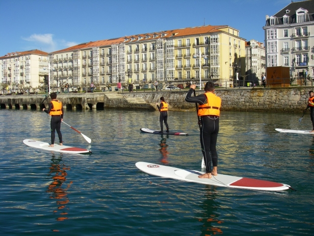  Paddle surfing in front of the urban area 